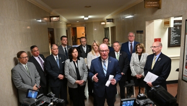 Senators standing in front of the Leg Correspondents Association offices